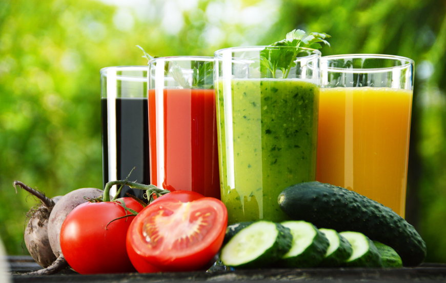 Glasses with fresh vegetable juices in the garden. Detox diet.