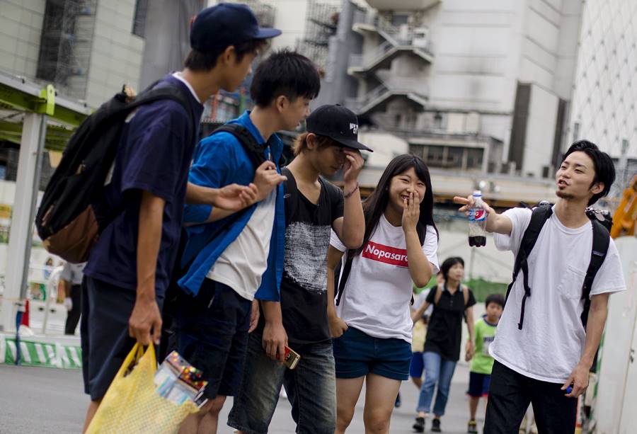 Aki Okuda (R), founding member of the protest group Students Emergency Action for Liberal Democracy (SEALDs), talks to supporters in central Tokyo, August 24, 2015. The group of student activists has emerged in a fresh front to protests against Prime Minister Shinzo Abe's push for a more robust defence policy, denting the image of Japanese students as apolitical introverts or rightwing geeks and representing the most significant student protesters since the 1960s. Picture taken August 24, 2015. REUTERS/Thomas Peter